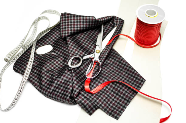 Bright fabrics, antique scissors and spools of thread on a table needlewoman.